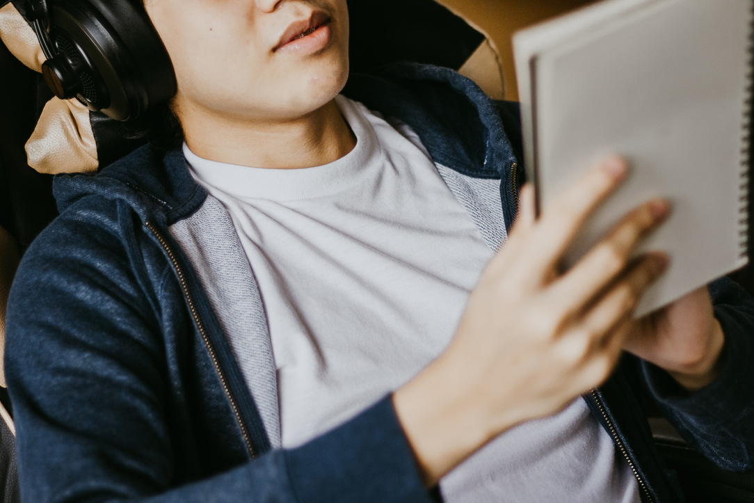 Student with Headphones Studying at Home